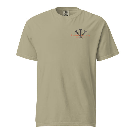 Front view of the khaki Known Society men’s Christian T-shirt featuring a three-nail logo and Isaiah 43:1.