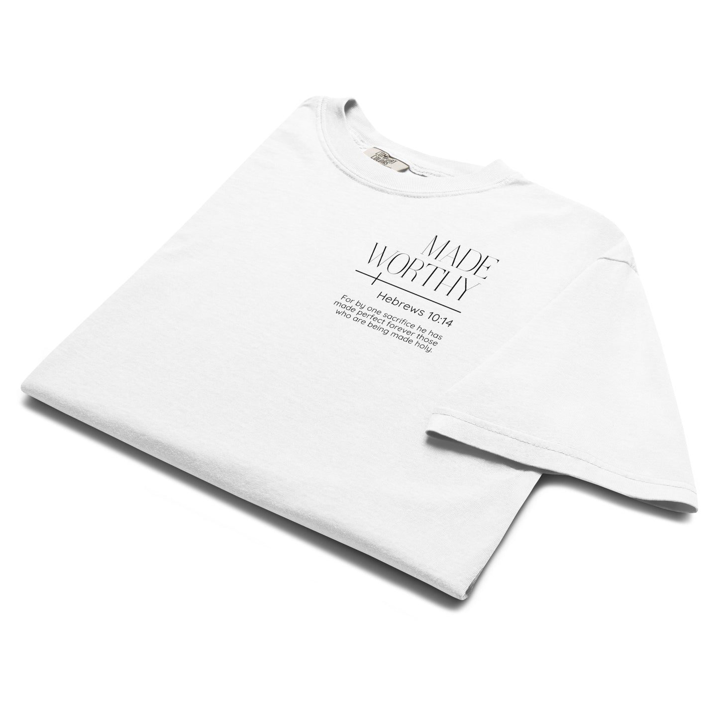 Folded white Made Worthy Hebrews 10:14 Christian tee showing the left chest Scripture graphic.