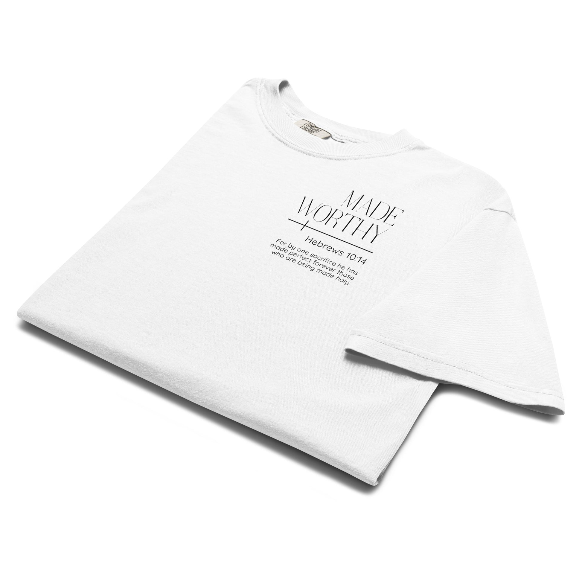 Folded white Made Worthy Hebrews 10:14 Christian tee showing the left chest Scripture graphic.