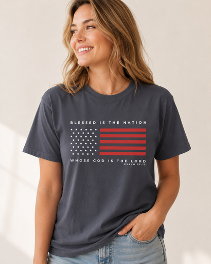 Joyful woman wearing a navy Blessed Is the Nation Psalm 33:12 Christian patriotic T-shirt.