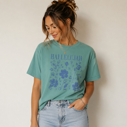 Woman wearing a seafoam Hallelujah Christian floral T-shirt with light-wash jeans