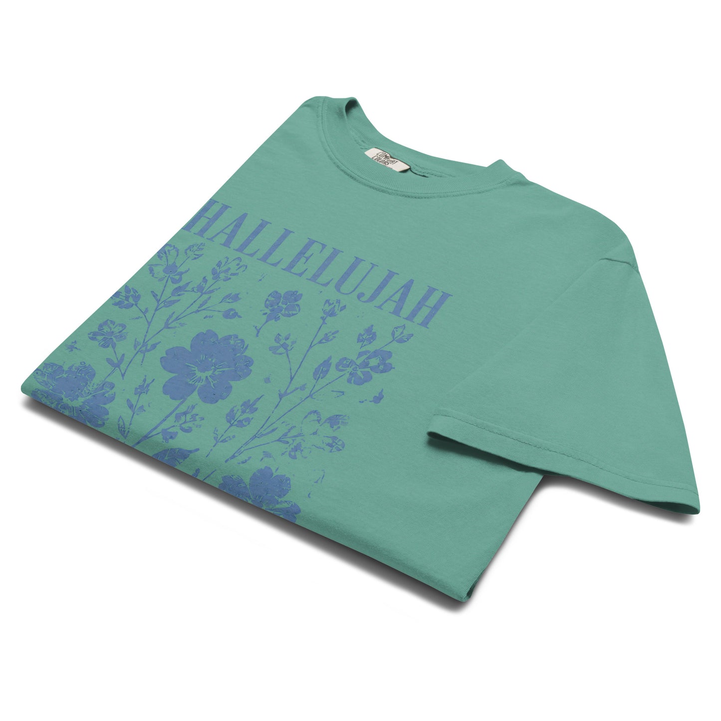 Angled close-up of the seafoam Hallelujah T-shirt with distressed blue wildflower artwork