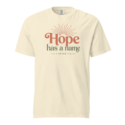 Ivory women’s Christian T-shirt with Hope Has a Name and 1 Peter 1:3 sunrise graphic, front view