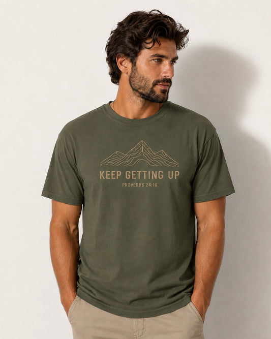 Male model wearing sage Keep Getting Up Christian T-shirt featuring Proverbs 24:16