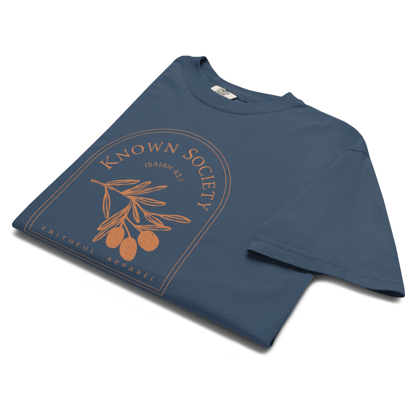 Angled close-up of the midnight blue Known Society Christian T-shirt with an Isaiah 43:1 olive branch design.
