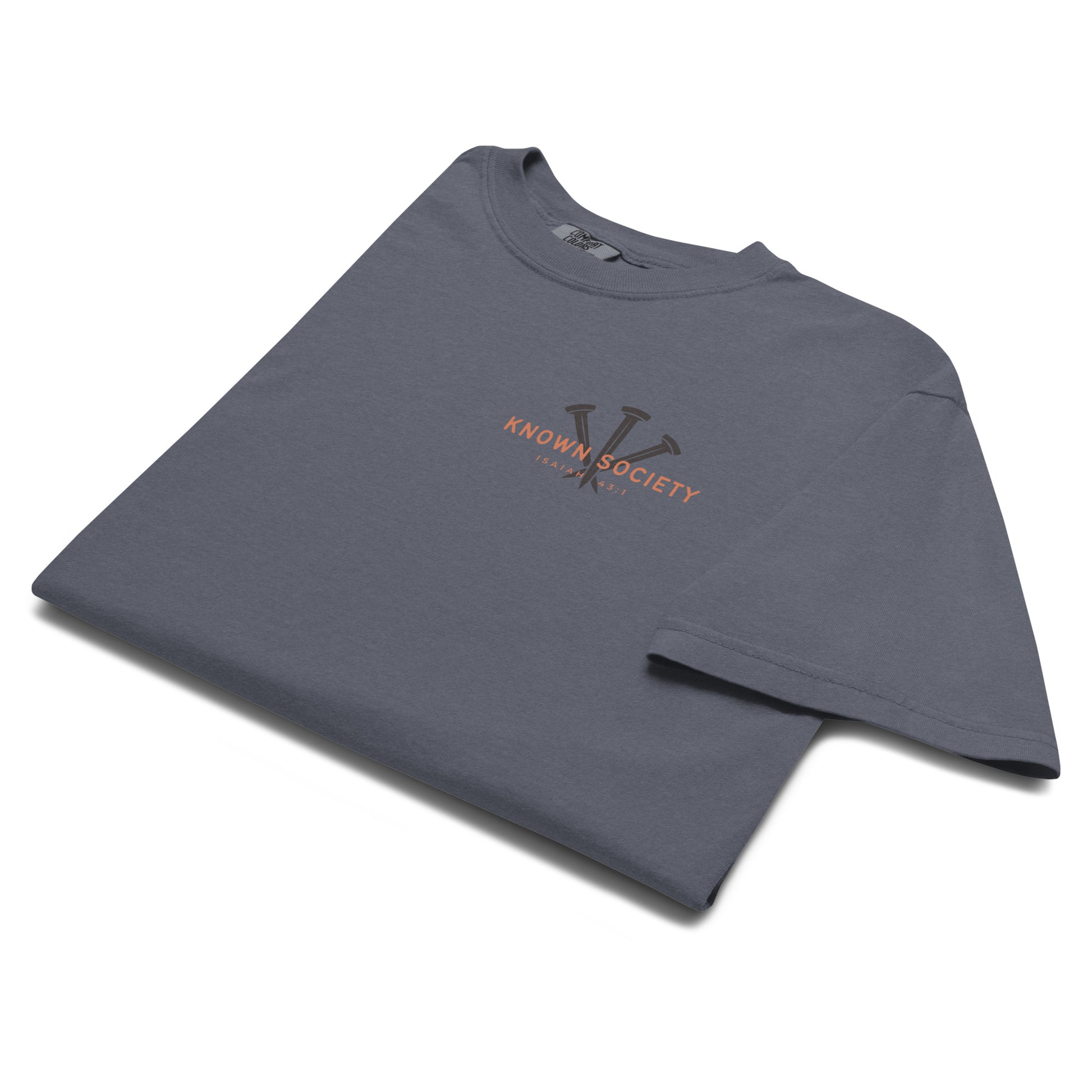 Folded denim blue Known Society Christian T-shirt featuring the three-nail logo and Isaiah 43:1 chest print.