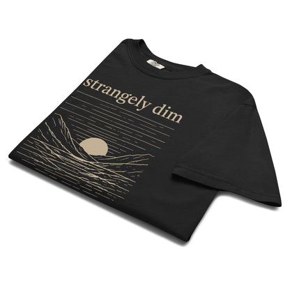 Angled close-up of black Strangely Dim Christian T-shirt featuring a vintage mountain and sunset design