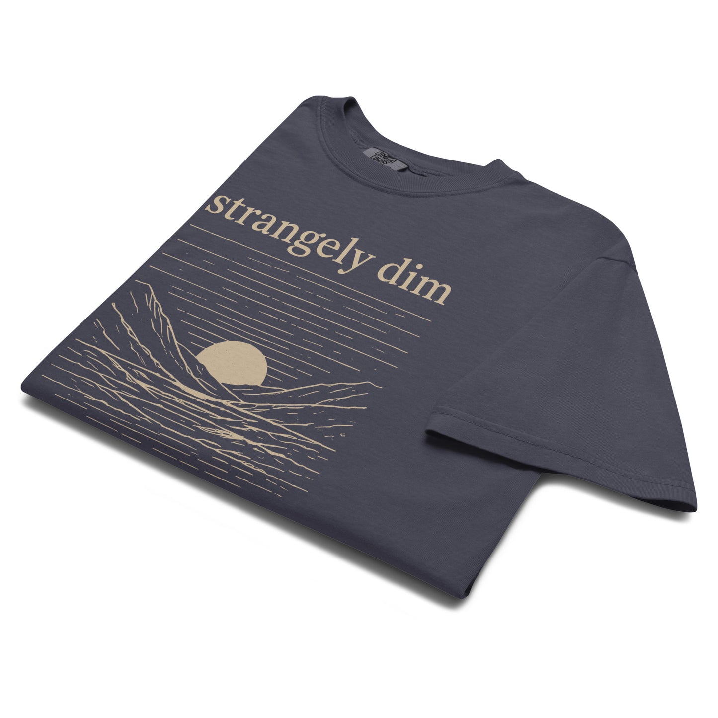 Angled close-up of navy Strangely Dim men’s Christian graphic tee with mountain and sunset artwork