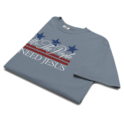 Angled view of the Blue Jean We the People Need Jesus women’s patriotic Christian T-shirt.